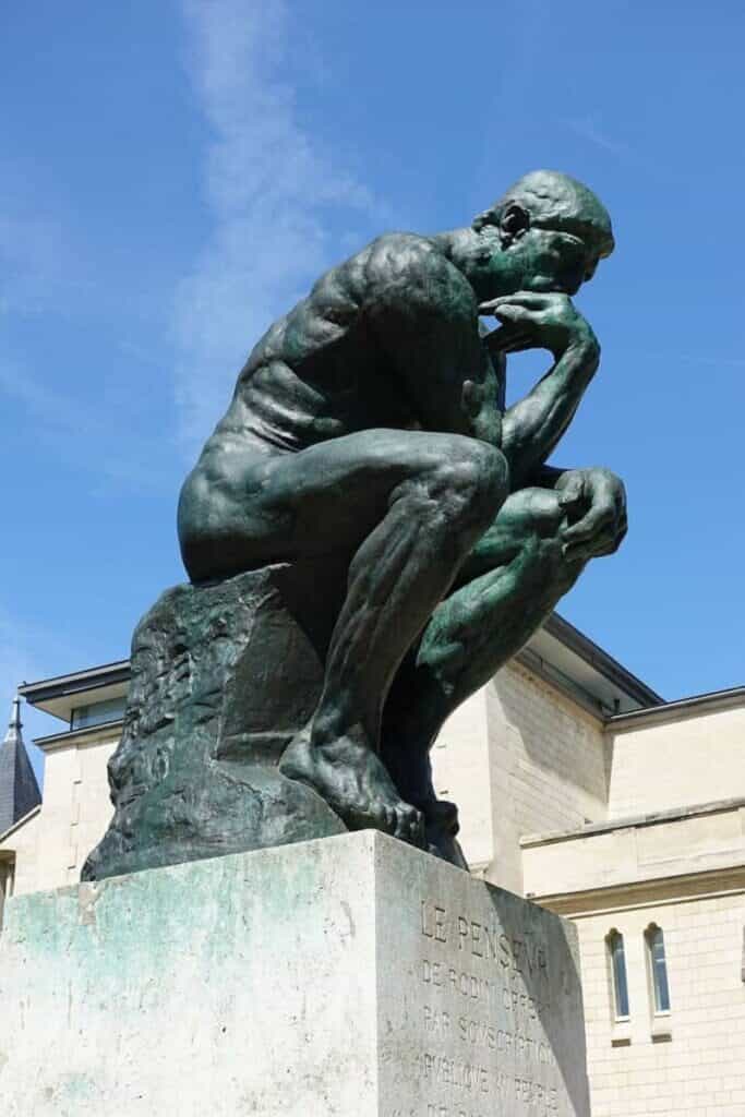 A photo of the Rodin statue, a man thinking… but also he’s naked.