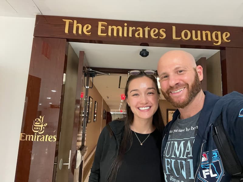 Couple standing at the entrance of the Emirate business class lounge at the New York - JFK airport. 